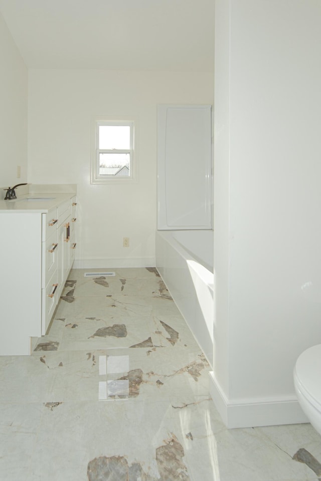 bathroom featuring vanity and toilet