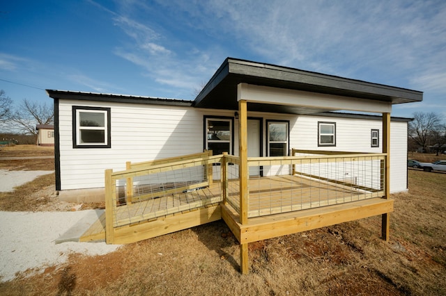 back of house featuring a wooden deck