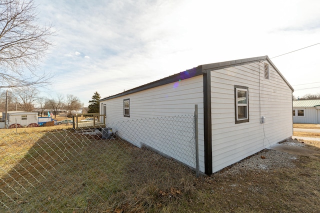 view of side of home with a yard