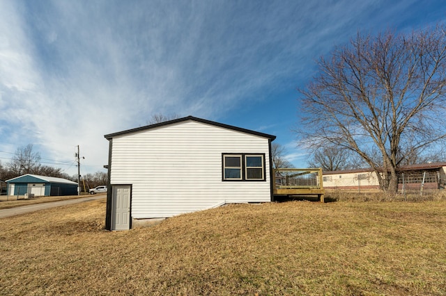 view of side of property with a lawn