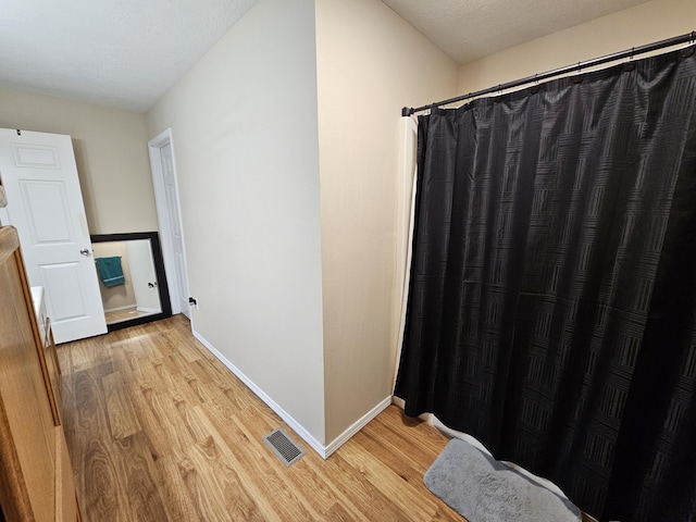 bathroom with hardwood / wood-style floors