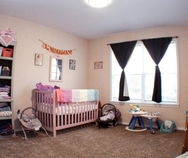 bedroom featuring carpet floors and a crib