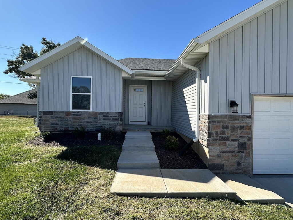 entrance to property featuring a lawn