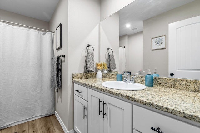 bathroom with hardwood / wood-style flooring and vanity