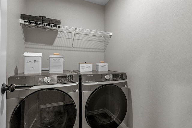 clothes washing area with separate washer and dryer