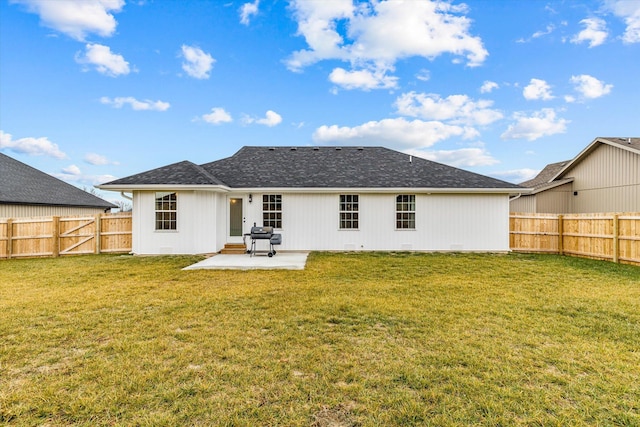 rear view of property with a patio and a lawn