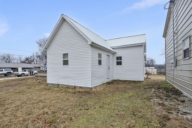 view of property exterior with a lawn