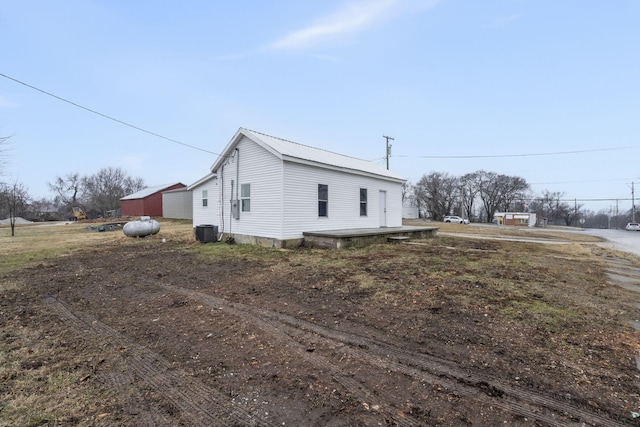 view of side of property featuring central AC