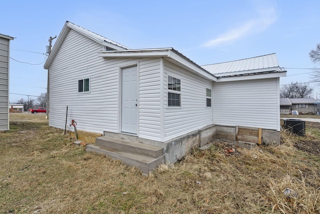 rear view of property featuring a yard