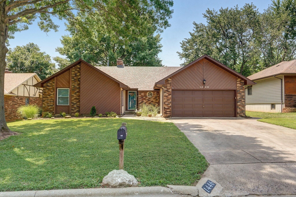 view of front of property featuring a garage and a front lawn