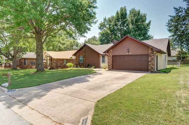 view of front of home with a garage and a front lawn