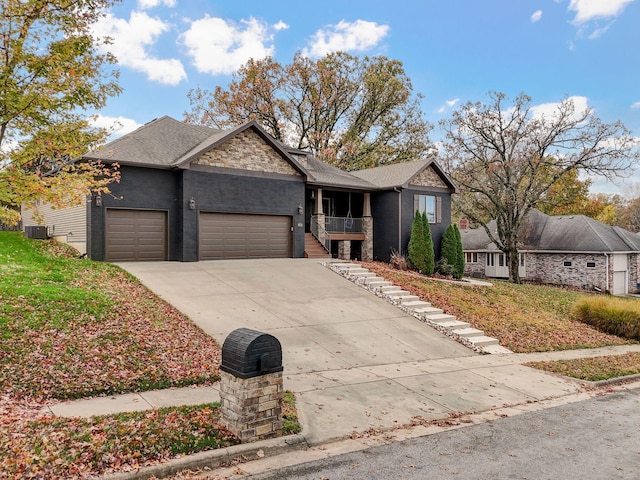 view of front of property with a garage and central AC unit