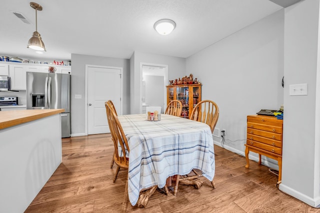 dining area with light wood-type flooring