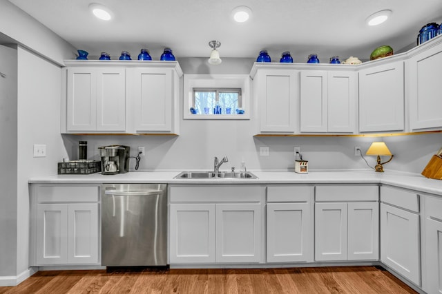 kitchen with white cabinetry, stainless steel dishwasher, sink, and light wood-type flooring