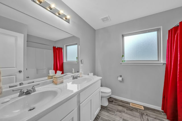 bathroom featuring vanity, a shower with curtain, and toilet