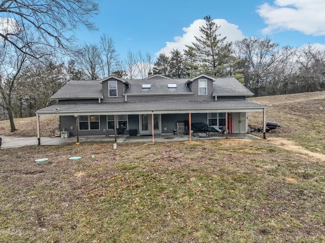 view of front of home featuring a front lawn and a patio area