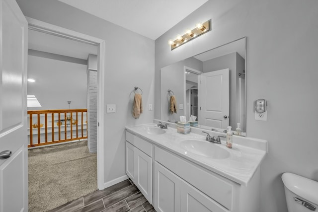 bathroom with vanity, wood-type flooring, and toilet