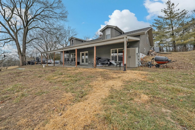 back of house featuring a lawn and a patio