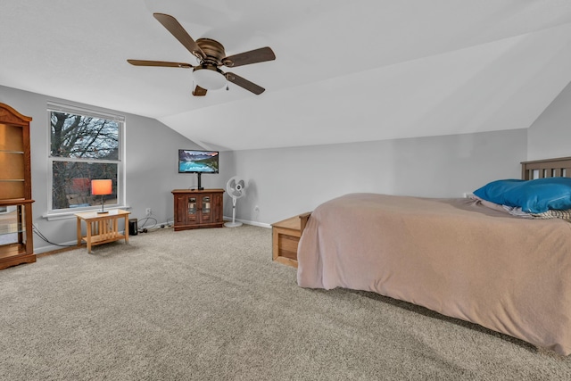 bedroom with vaulted ceiling, carpet flooring, and ceiling fan