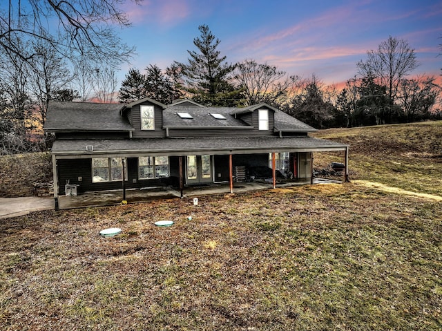 view of front of home featuring a yard and a patio area