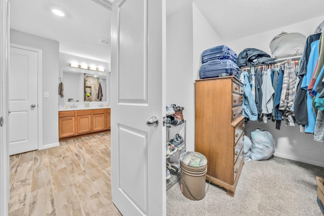 walk in closet featuring sink