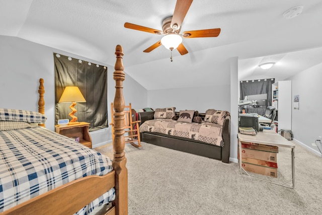 bedroom with vaulted ceiling, carpet flooring, and ceiling fan