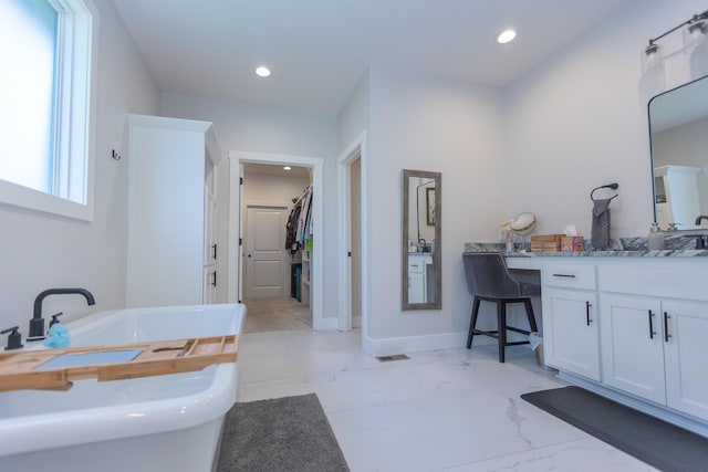 bathroom with vanity and a bathing tub