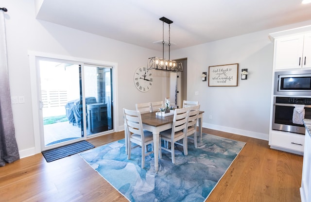 dining room with an inviting chandelier and hardwood / wood-style floors