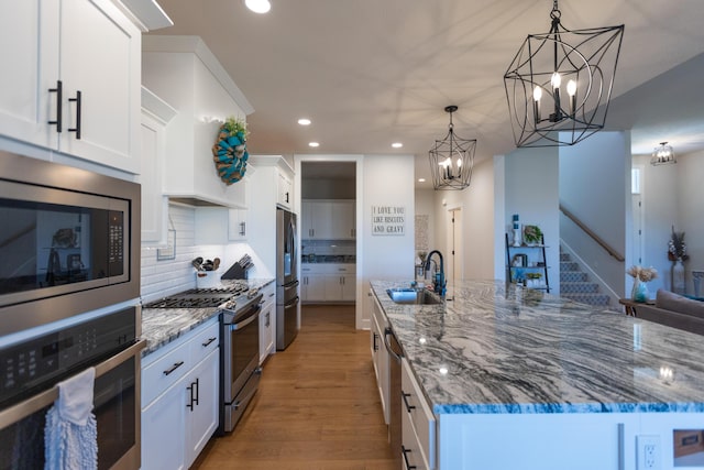 kitchen featuring sink, white cabinets, and appliances with stainless steel finishes