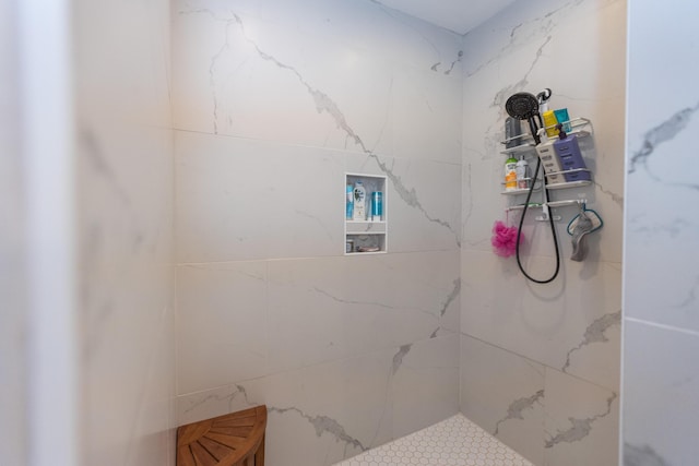 bathroom with tiled shower