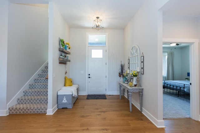 entrance foyer with an inviting chandelier and light hardwood / wood-style flooring