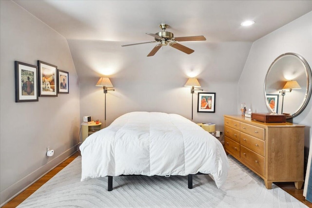 bedroom with lofted ceiling, hardwood / wood-style flooring, and ceiling fan