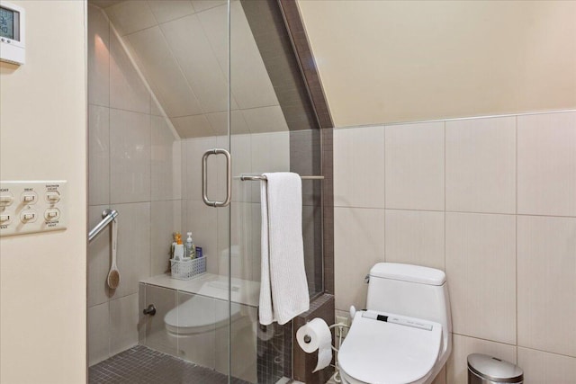 bathroom featuring walk in shower, toilet, and tile walls