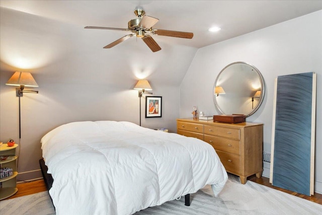 bedroom featuring lofted ceiling, ceiling fan, and light hardwood / wood-style flooring