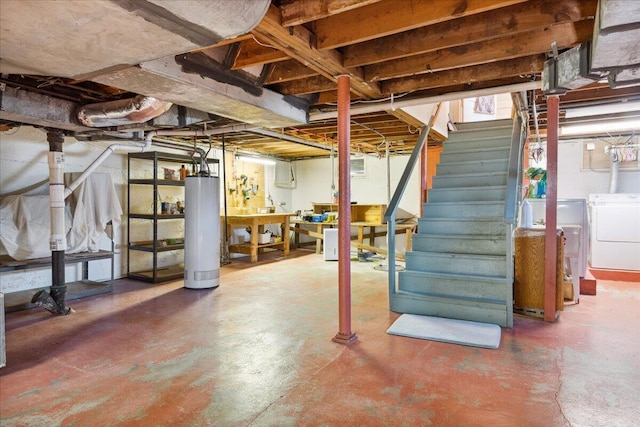 basement featuring water heater and independent washer and dryer