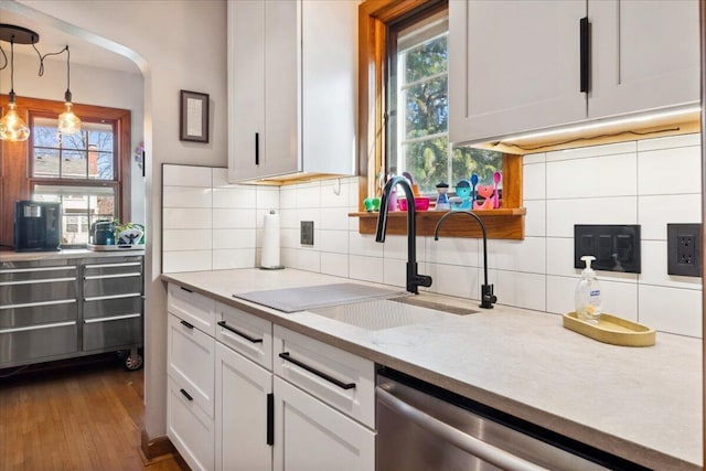 kitchen featuring white cabinetry, dishwasher, sink, and pendant lighting