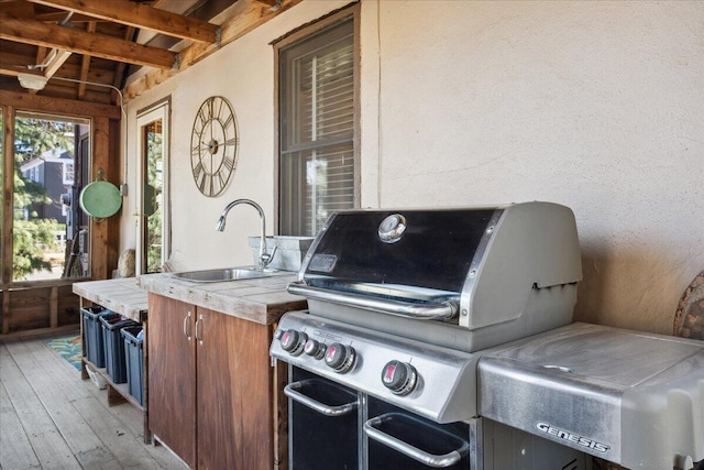 view of patio featuring an outdoor wet bar, a deck, and grilling area