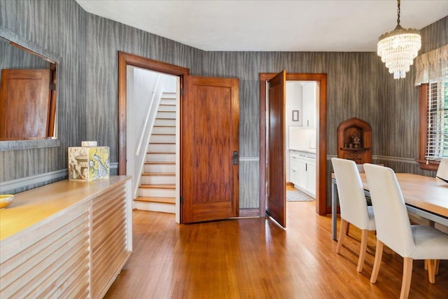 dining room featuring wood-type flooring and a notable chandelier