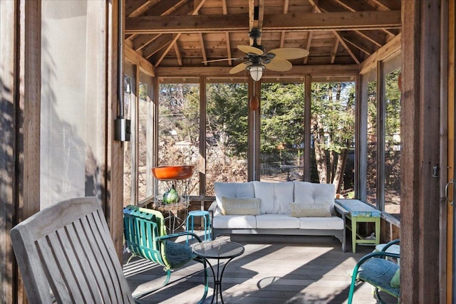 sunroom / solarium featuring lofted ceiling and ceiling fan