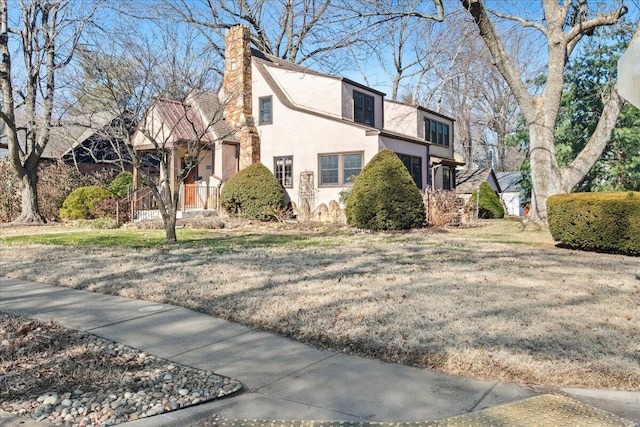 view of property exterior with a lawn