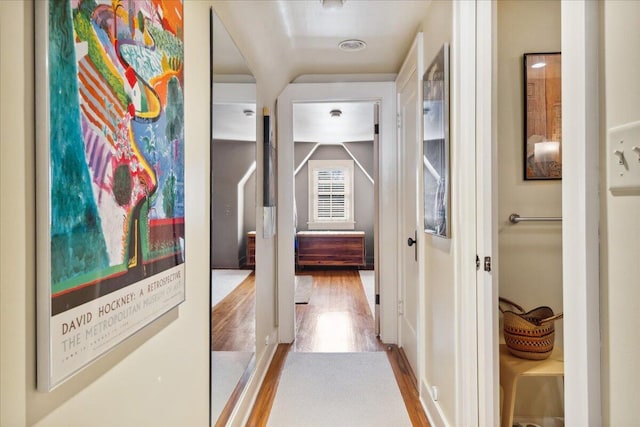 hallway with light hardwood / wood-style floors