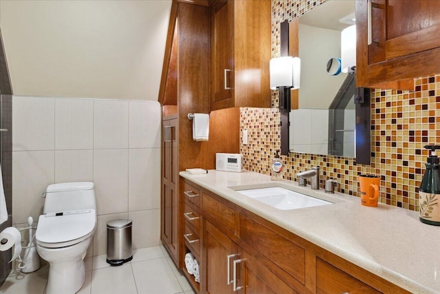 bathroom with tile patterned flooring, vanity, tile walls, and toilet