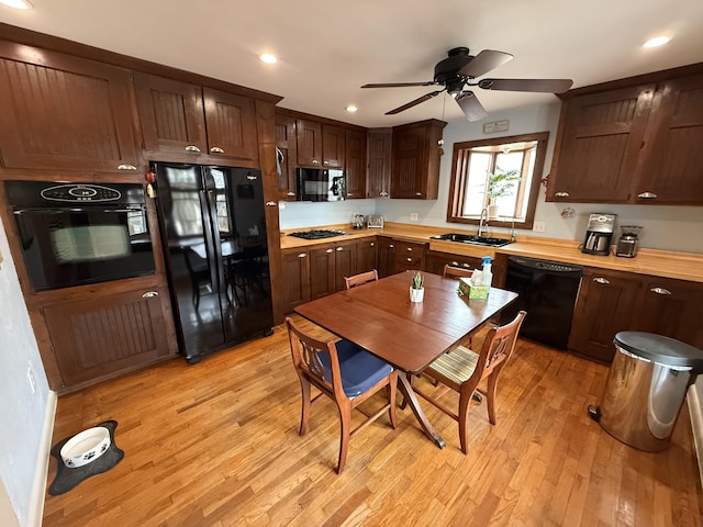 kitchen with sink, light hardwood / wood-style flooring, ceiling fan, and black appliances