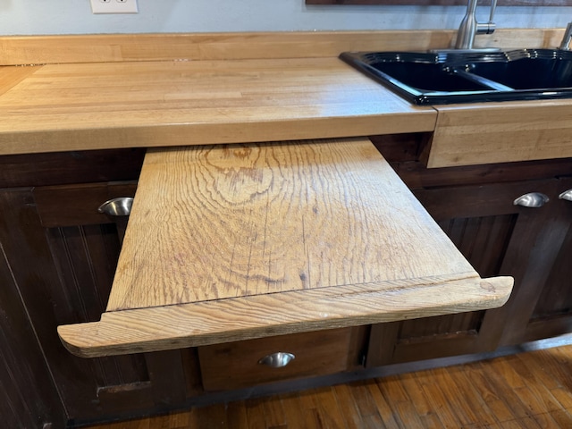 details featuring sink and dark hardwood / wood-style flooring