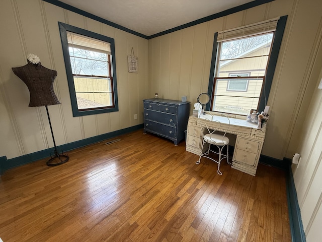 unfurnished office with crown molding, plenty of natural light, and dark hardwood / wood-style flooring