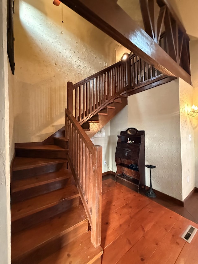 stairway with hardwood / wood-style floors