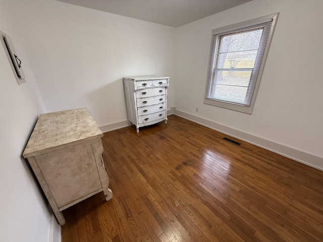 unfurnished bedroom featuring dark hardwood / wood-style flooring