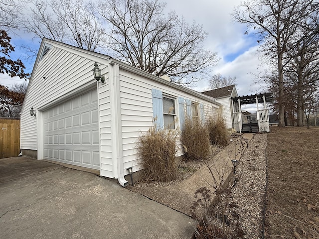 view of property exterior with a garage and an outbuilding