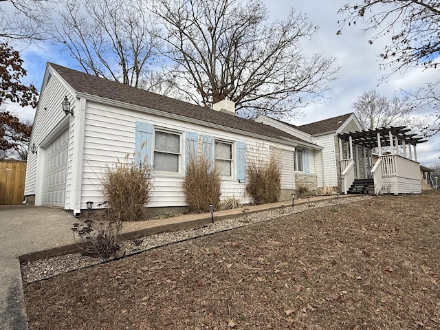 view of front of house with a garage and a pergola