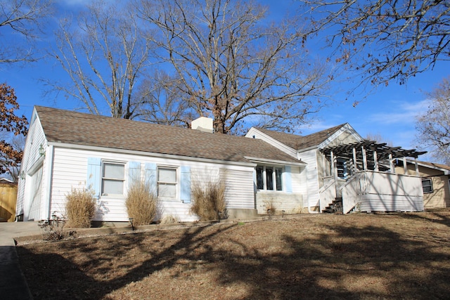 view of side of property featuring a pergola and a lawn